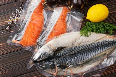 Products in vacuum packaging, on a wooden board. vegetables, fish meat, dolma, kurza. Quarantine Pandemic